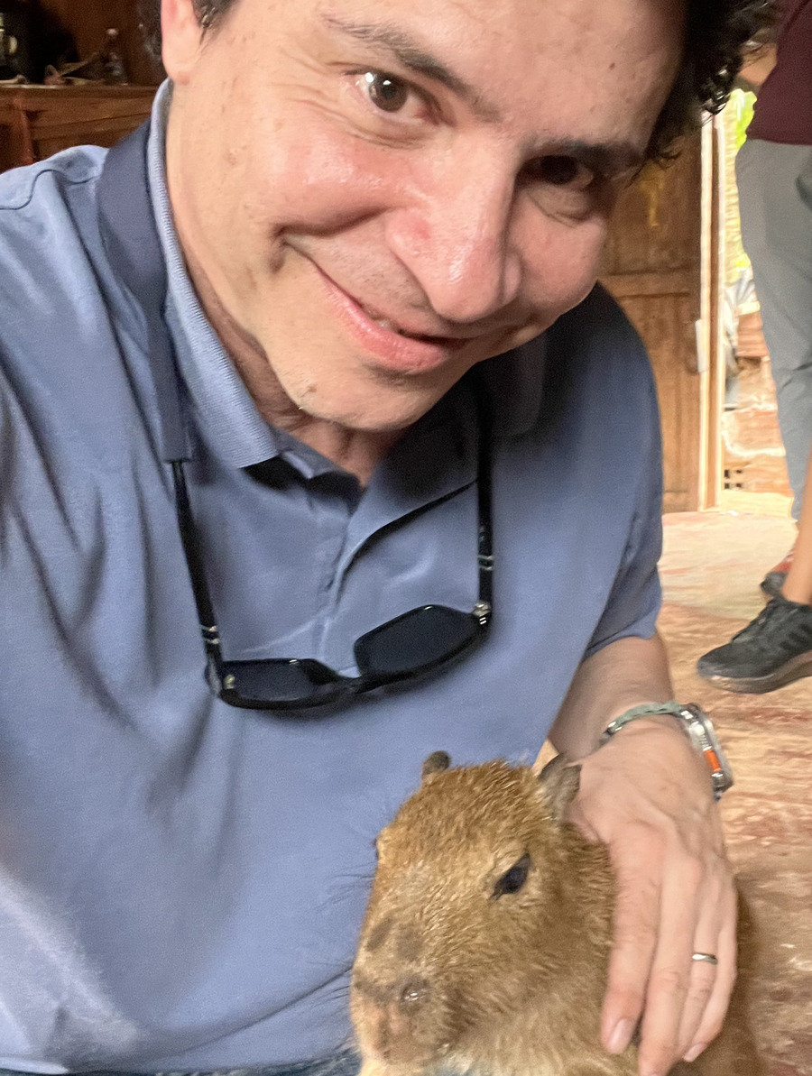 Kim Chaix with a capybara in Latin America